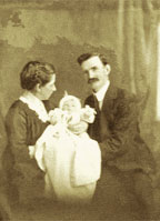 Photograph of a husband and wife and their baby.